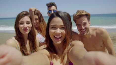 Group-of-Friends-Taking-Selfie-on-Sunny-Beach