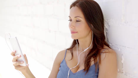 Attractive-woman-listening-to-music-on-earphones