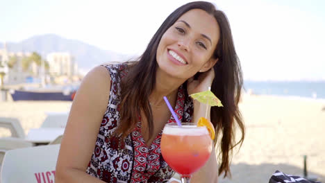 Happy-friendly-woman-drinking-a-tropical-cocktail