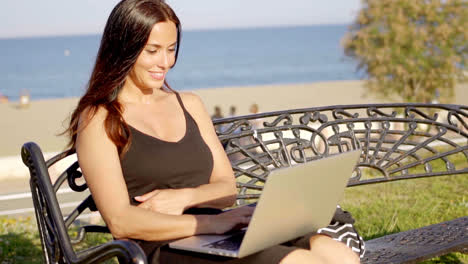 Attractive-woman-working-outdoors-on-a-laptop