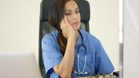 Serious-female-doctor-at-laptop-computer
