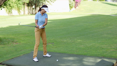 Young-female-golfer-preparing-to-tee-off