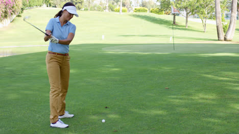 Woman-golfer-about-to-play-a-stroke-on-the-green