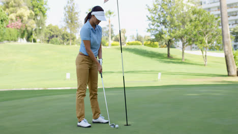 Woman-golfer-about-to-sink-her-putt