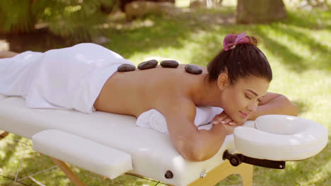 Young-woman-enjoying-a-hot-stone-massage