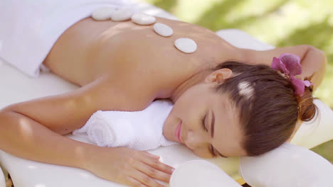 Pretty-young-woman-having-a-hot-stone-massage