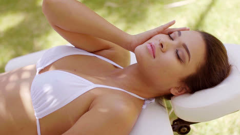 Relaxed-young-woman-lying-on-a-spa-bed