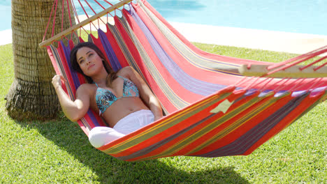 Relaxing-young-woman-in-colorful-hammock