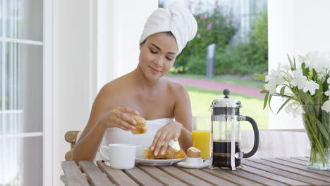Woman-in-towel-dipping-donut-in-coffee