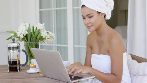 Beautiful-woman-in-bath-towel-using-laptop