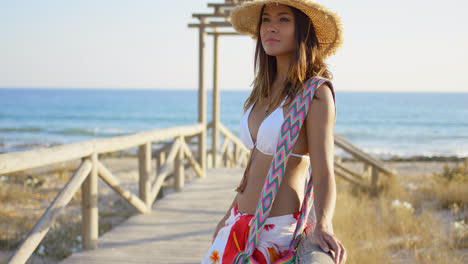 Young-woman-on-a-wooden-beachfront-promenade