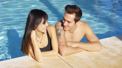 Handsome-brown-haired-couple-in-blue-pool