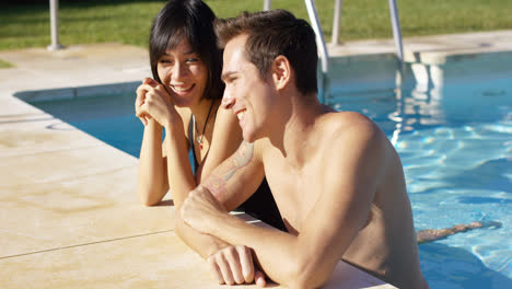 Diverse-good-looking-couple-stand-in-swimming-pool