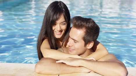 Beautiful-woman-cuddles-with-her-boyfriend-in-pool