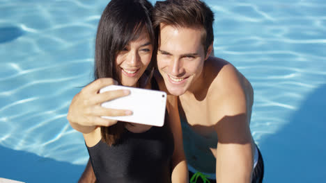 Handsome-couple-take-photo-while-standing-in-pool