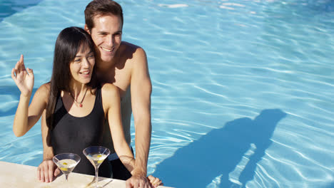 Loving-couple-smooching-at-swimming-pool