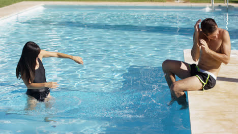 Girlfriend-splashing-her-boyfriend-at-pool
