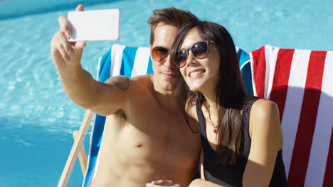 Smiling-young-couple-taking-a-vacation-selfie