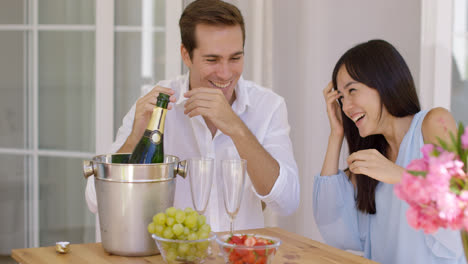 Shocked-young-couple-during-champagne-opening