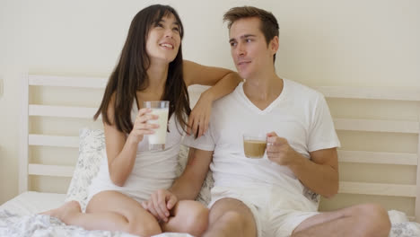 Man-and-woman-having-breakfast-in-bed