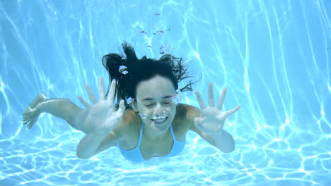 Happy-young-woman-smiling-underwater