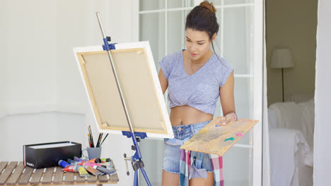 Artistic-young-woman-working-on-a-painting