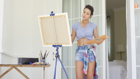Attractive-woman-artist-painting-on-her-patio