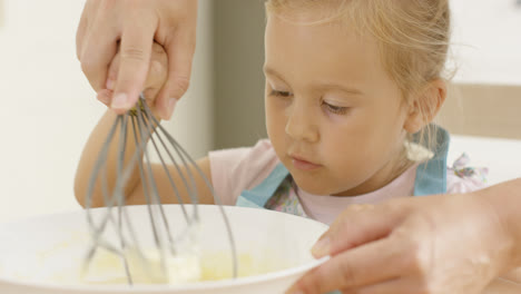 Fascinated-little-girl-learning-to-bake