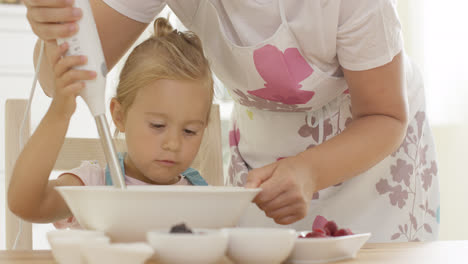 Serious-pretty-little-girl-concentrating-on-baking