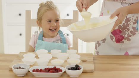 Little-girl-laughing-as-she-helps-with-the-baking
