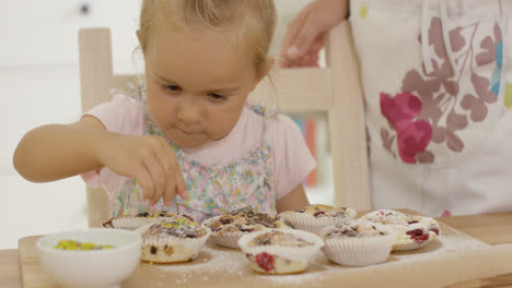 Close-up-on-girl-helping-to-prepare-muffins