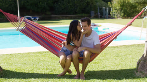 Loving-couple-in-hammock-kissing-each-other