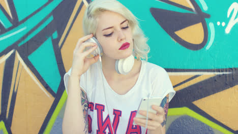Trendy-young-woman-with-tattoos-listening-to-music