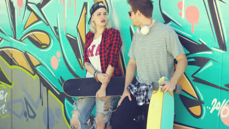 Trendy-modern-urban-couple-chatting-at-skate-park