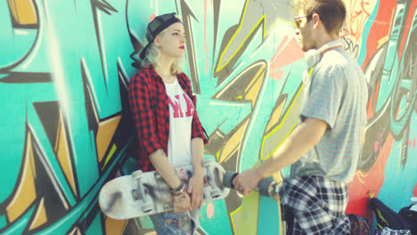 Couple-of-young-skateboards-standing-chatting