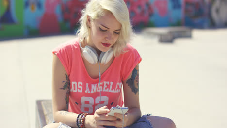 Young-woman-searching-for-tunes-on-her-mobile