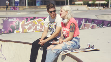 Man-chatting-to-his-girlfriend-at-a-skate-park