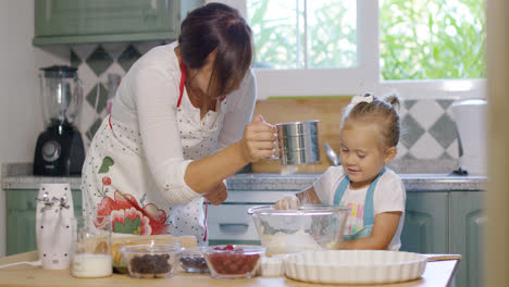 Young-mother-and-daughter-baking-in-the-kitchen