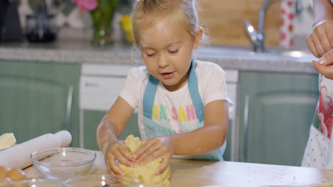Little-girl-having-fun-kneading-the-pastry