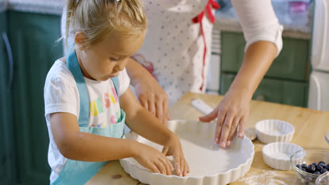 Cute-little-girl-greasing-a-baking-dish