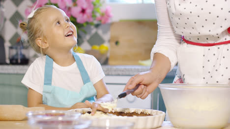 Smiling-happy-little-girl-baking-with-her-mother