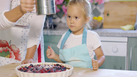 Adorable-little-girl-engrossed-in-baking-a-pie