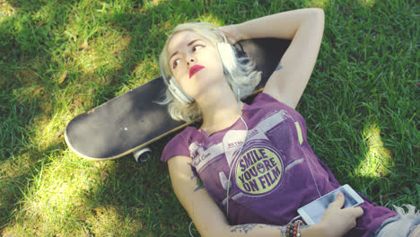 Young-blond-woman-relaxing-listening-to-music