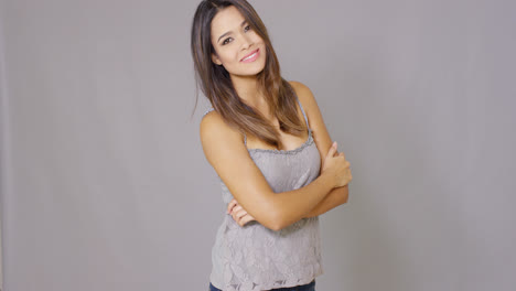 Beautiful-young-woman-folds-her-arms-and-smiles