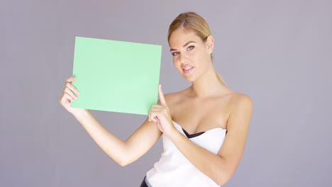 Happy-attractive-young-woman-with-a-blank-sign