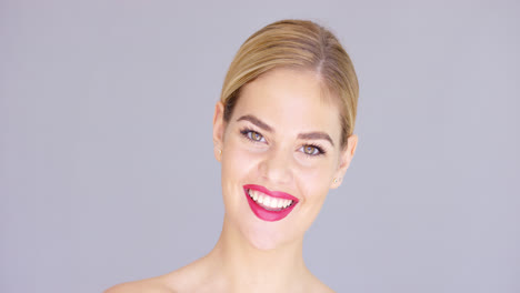 Laughing-young-woman-wearing-red-lipstick