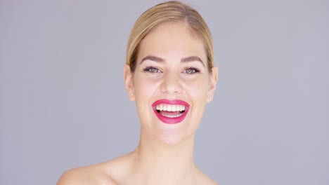 Laughing-young-woman-wearing-red-lipstick