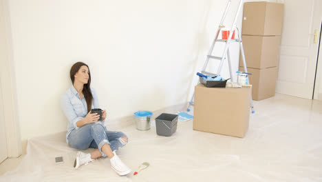Tired-young-woman-relaxing-during-renovations