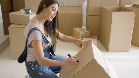 Attractive-woman-moving-house-and-packing