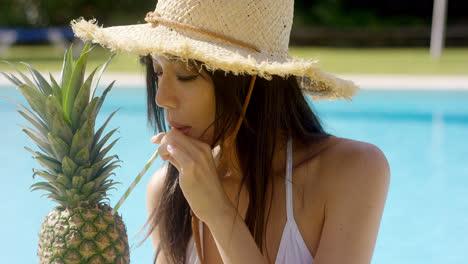 Young-woman-sipping-a-pineapple-cocktail